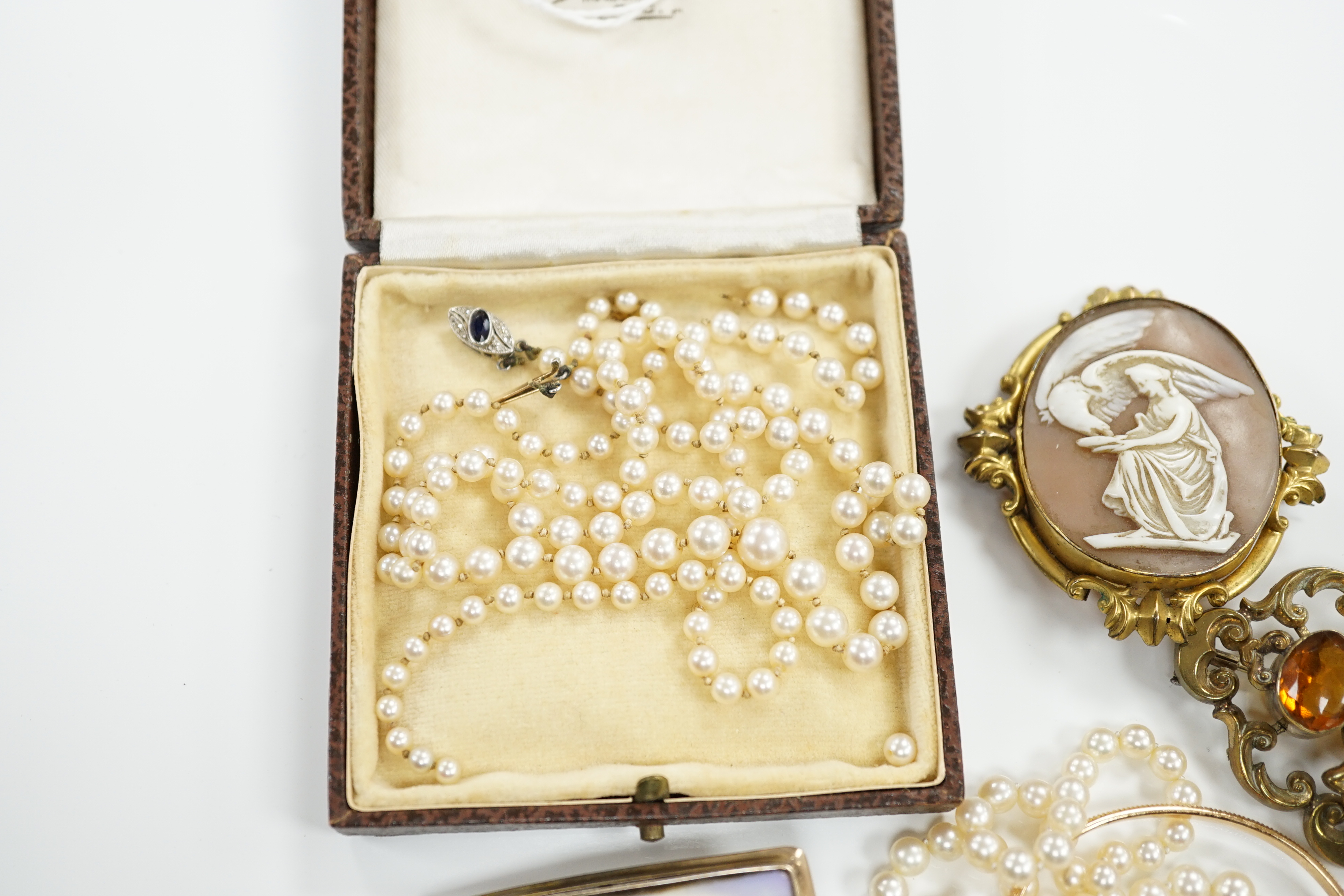 Three assorted single strand cultured pearl necklaces, two a.f. and one with sapphire and diamond set clasp and four other items.